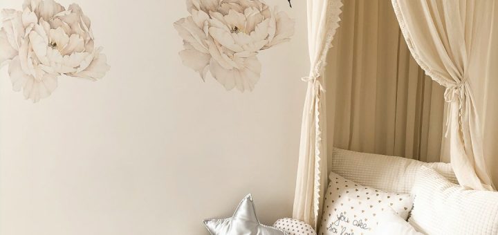 plush toys and throw pillows on bed with comforter