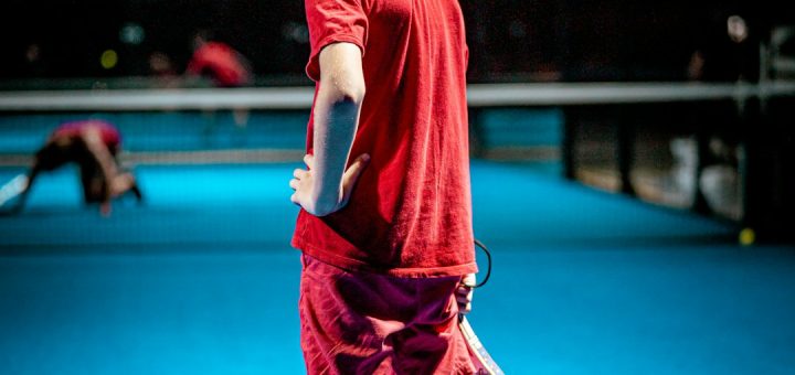 girl in red t-shirt and black pants running on blue floor