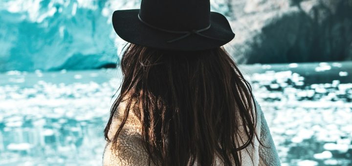 woman with a DLSR camera with icebergs