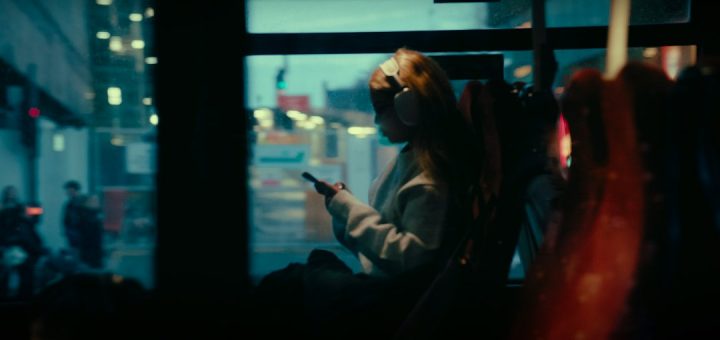 Woman on a bus looking at her phone