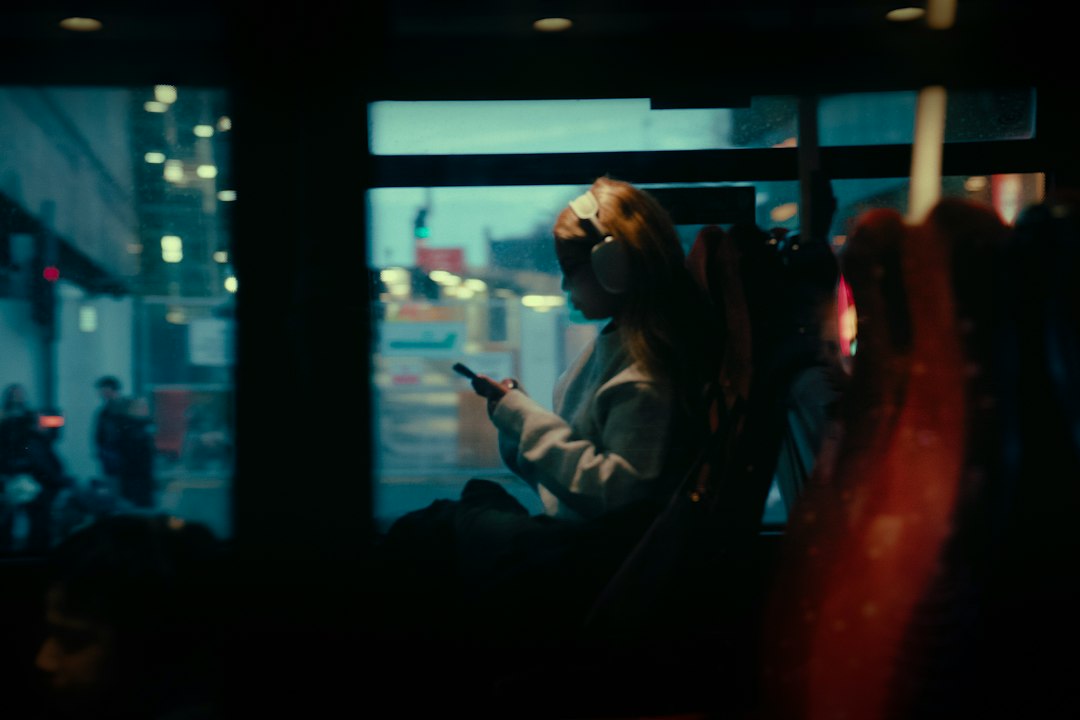 When to Activate a Digital Travel eSIM Before Going Overseas 1 Woman on a bus looking at her phone